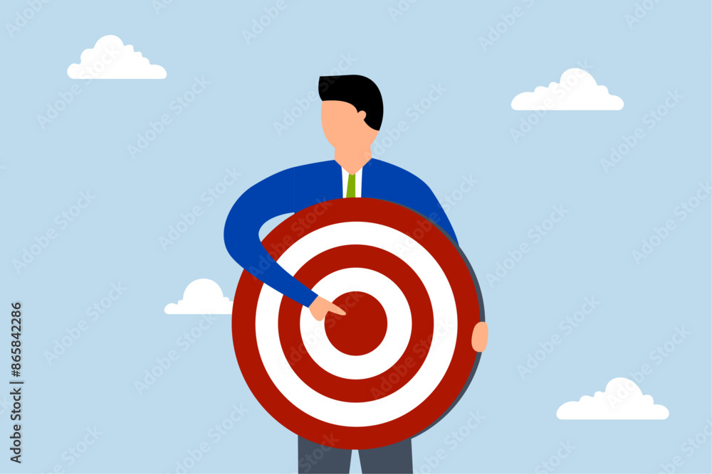 Focus on business target, businessman with archer target pointing at bullseye. Focus on business target, businessman with archer target pointing at bullseye.