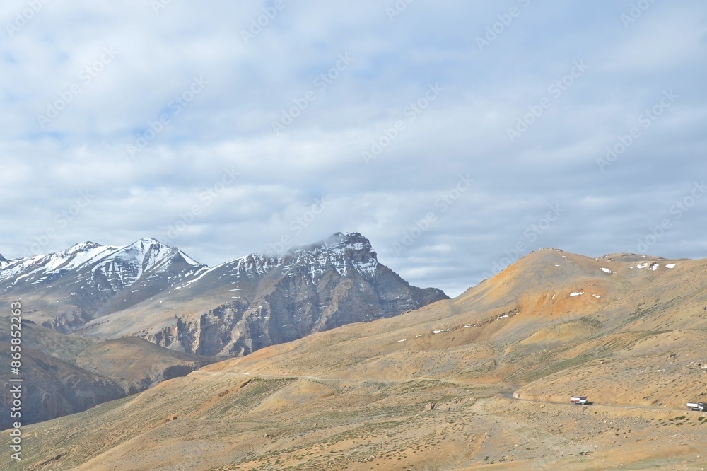 Leh Mountain Peaks Shrouded in Clouds under Clear Blue Sky Leh Mountain Peaks Shrouded in Clouds under Clear Blue Sky