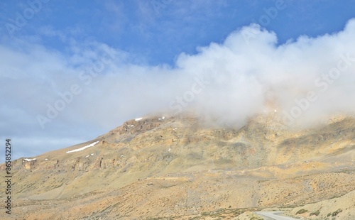 Leh Mountain Peaks Shrouded in Clouds under Clear Blue Sky