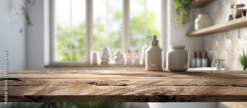 Wooden Table Against Blurred Bathroom Window and Shelves © Lasvu