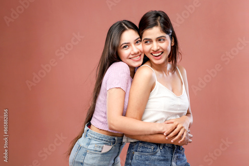 Two Good-Looking Ladies Are Hugging And Smiling While Standing