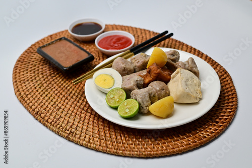 Siomay, a traditional Bandung dish, is a steamed dumpling made from mackerel fish and flour. It’s served with a rich peanut sauce, soy sauce, and chili sauce, offering a flavorful Indonesian culinary 