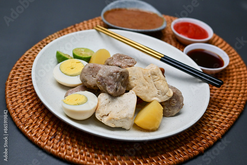 Siomay, a traditional Bandung dish, is a steamed dumpling made from mackerel fish and flour. It’s served with a rich peanut sauce, soy sauce, and chili sauce, offering a flavorful Indonesian culinary 