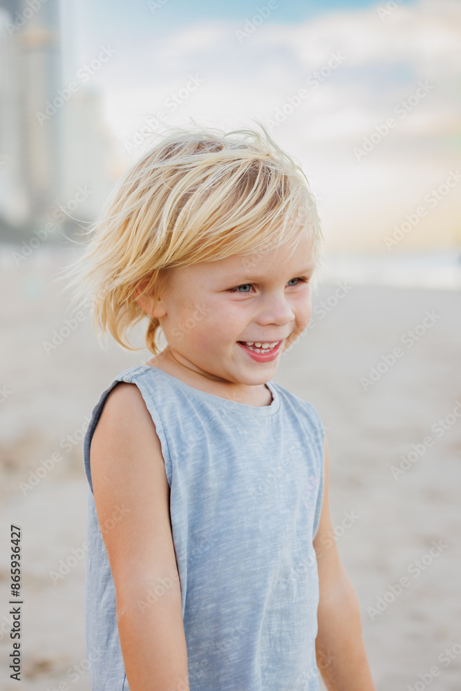 Happy little boy standing on the beach at the Gold Coast Happy little boy standing on the beach at the Gold Coast