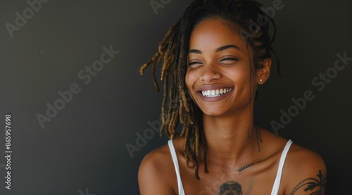 Portrait of a Smiling Woman With Dreads and Tattoos