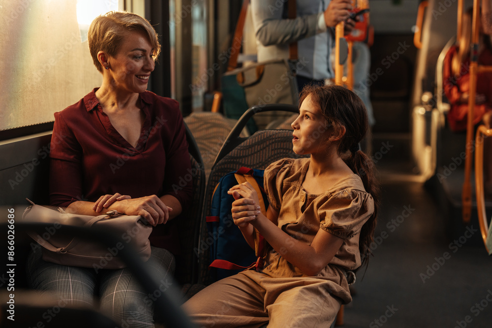 Child talking to a short-haired woman on a bus Child talking to a short-haired woman on a bus