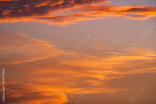 Dramatic sunset or sunrise scene. Pink and purple summer clouds against blue sky