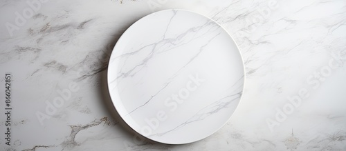 A blank white plate on a wh...