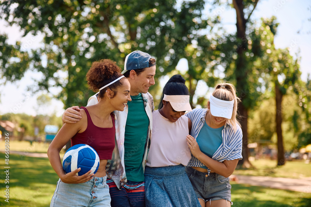 Fototapeta premium Young happy friends having fun playing volleyball in nature.