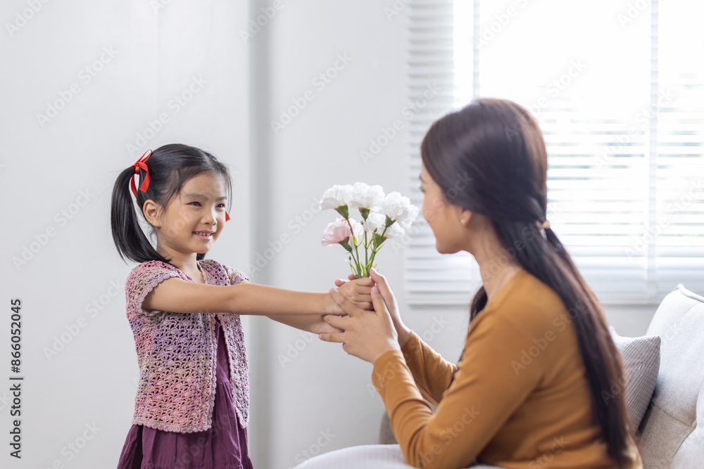 cheerful asian toddler daughter hugging happy mother Good time at home. cheerful asian toddler daughter hugging happy mother Good time at home.