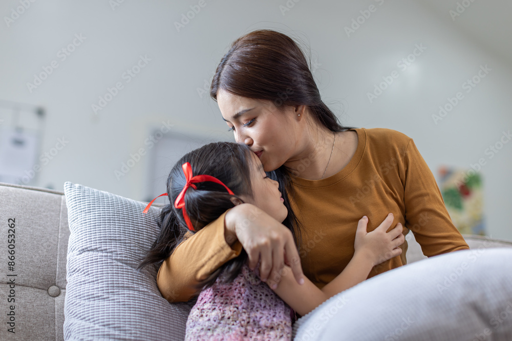 cheerful asian toddler daughter hugging happy mother Good time at home. cheerful asian toddler daughter hugging happy mother Good time at home.