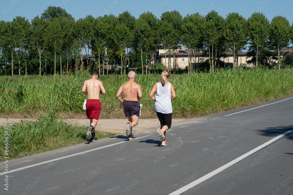 Man woman boy running road