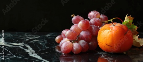 Ripe pink grapes and a pers...