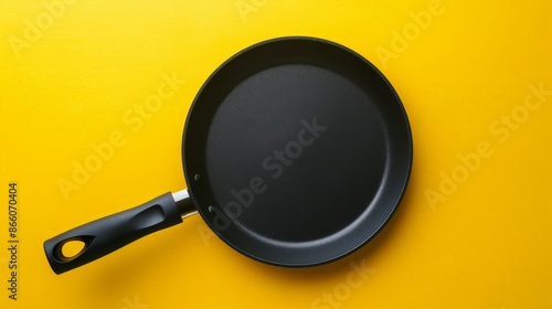 Black Frying Pan on a Yellow Background