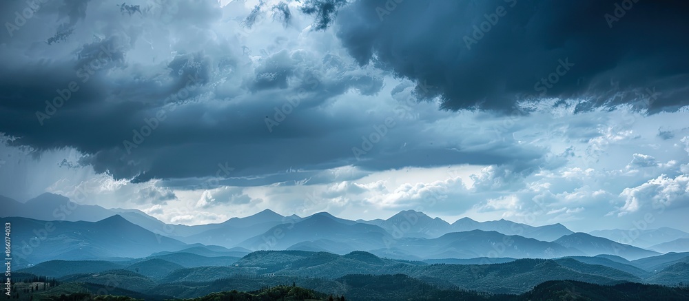 Storm clouds loom menacingly over the mountains against a backdrop of a gray sky; perfect for a copy space image. Storm clouds loom menacingly over the mountains against a backdrop of a gray sky; perfect for a copy space image.