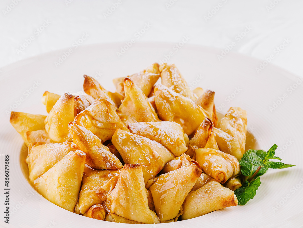 Golden caramelized apple pancakes dessert on white plate Golden caramelized apple pancakes dessert on white plate