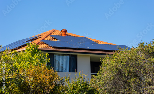 A solar panel array facing in two directions on a house roof in order to reduce coal fired power generation and to reduce energy bills in a suburban area on the Gold Coast in Queensland, Australia