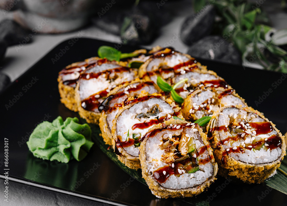 Delectable tempura sushi roll with spicy sauce Delectable tempura sushi roll with spicy sauce
