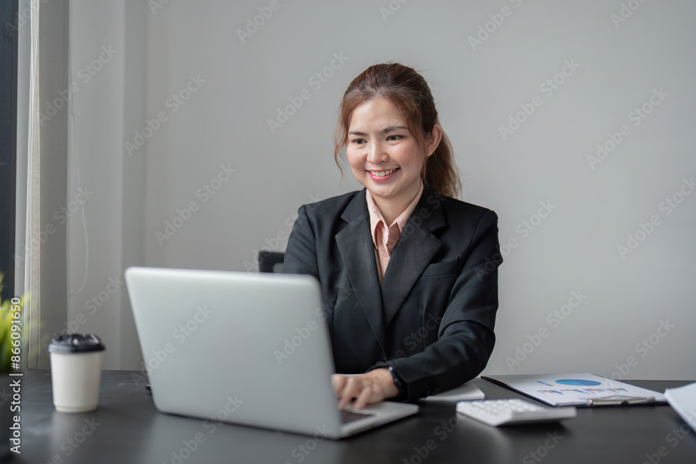 Professional Businesswoman Working on Laptop in Modern Office Environment Professional Businesswoman Working on Laptop in Modern Office Environment