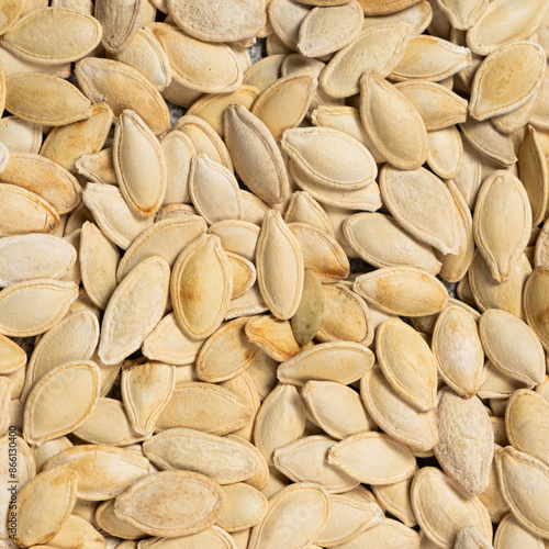 Close-up of unpeeled pumpkin seeds from above.