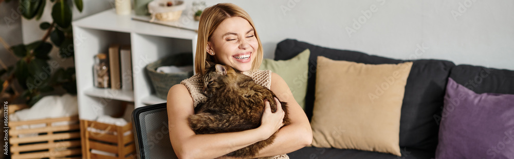 A woman with short hair in a relaxed pose on a couch, holding a content cat in her arms. A woman with short hair in a relaxed pose on a couch, holding a content cat in her arms.
