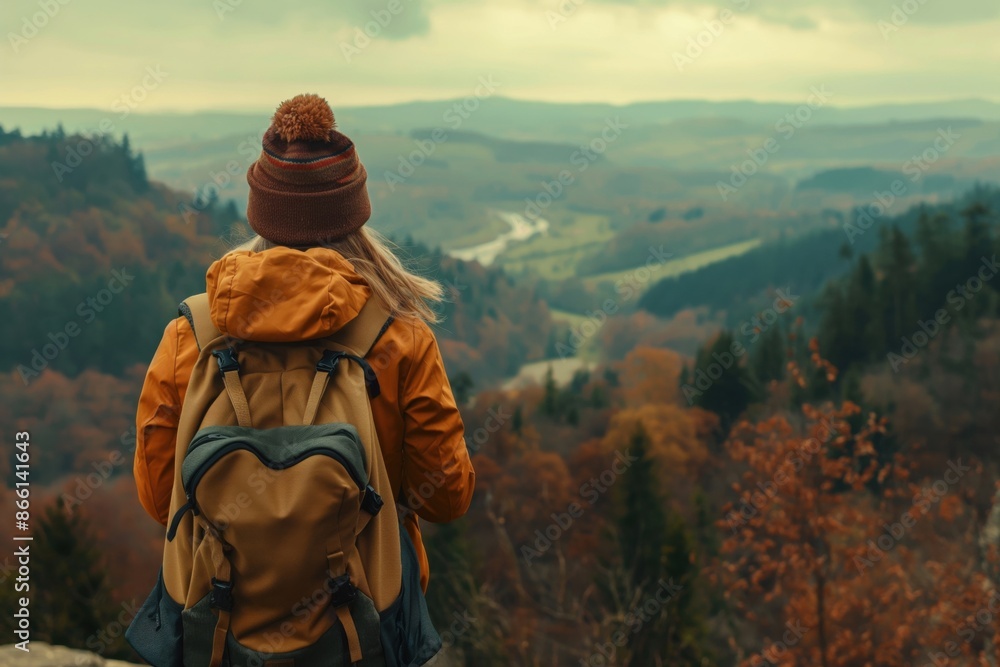 A woman with a backpack overlooking a beautiful valley and admiring a stunning natural landscape. Solo female travel and adventure travel concept. A woman with a backpack overlooking a beautiful valley and admiring a stunning natural landscape. Solo female travel and adventure travel concept.