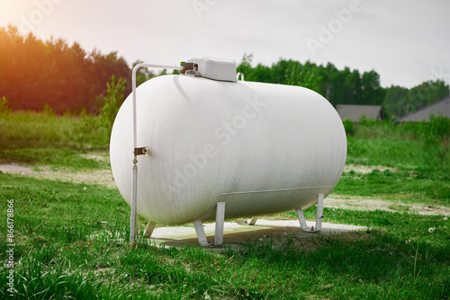 Fotografi Rural home with large white propane gas tank