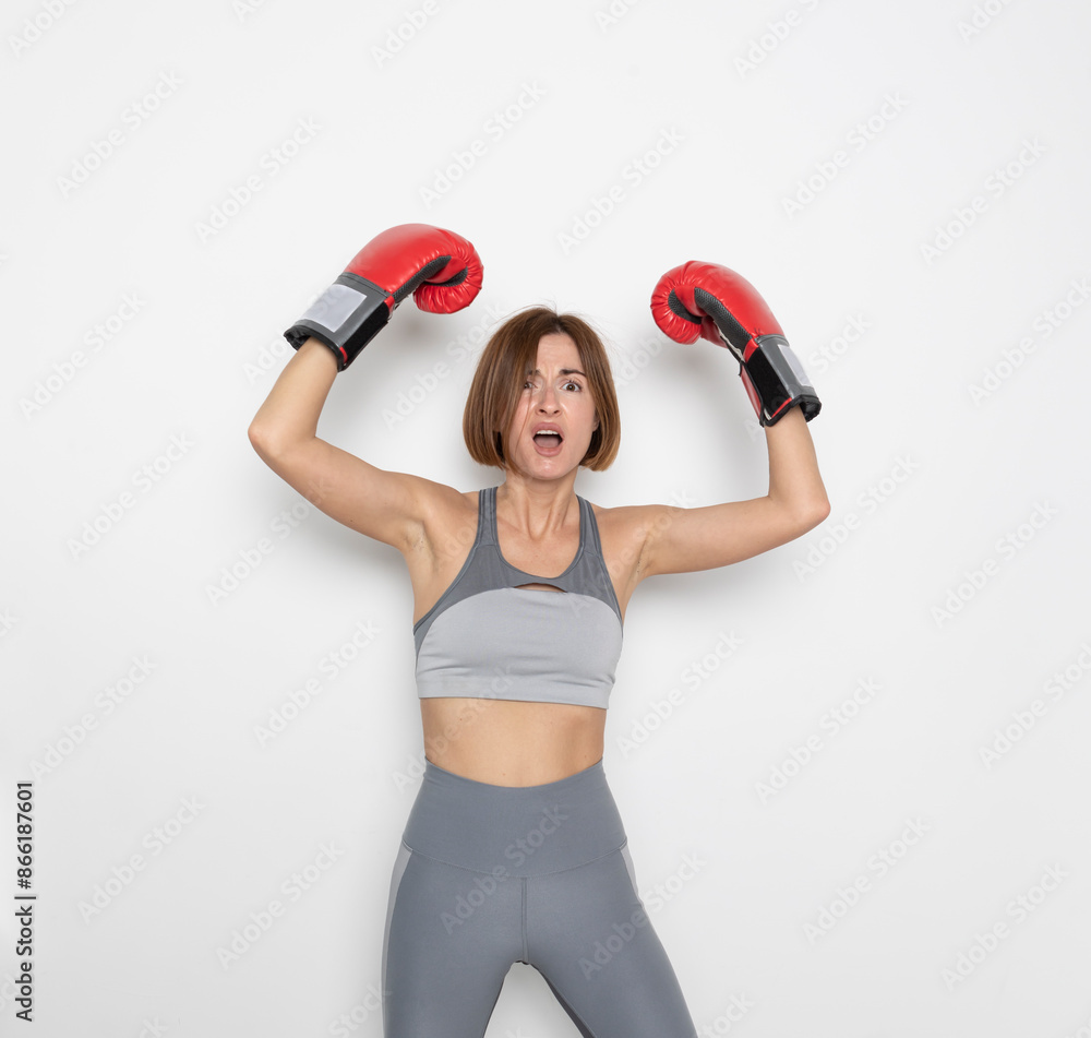 Young and attractive woman in boxing gloves posing isolated on white background Young and attractive woman in boxing gloves posing isolated on white background