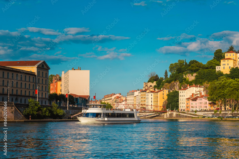 Obraz premium A Tourboat in the Saône River at sunset, Lyon, France