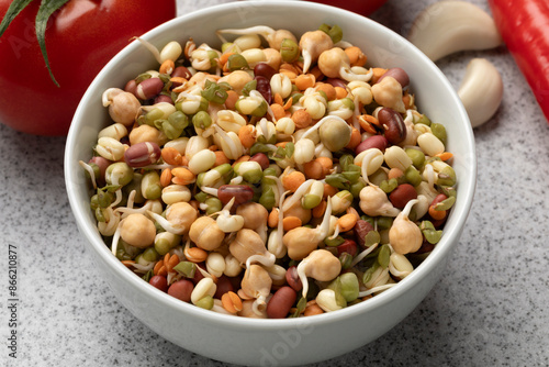 Bowl with a mixture of fresh colorful sprouts close up photo