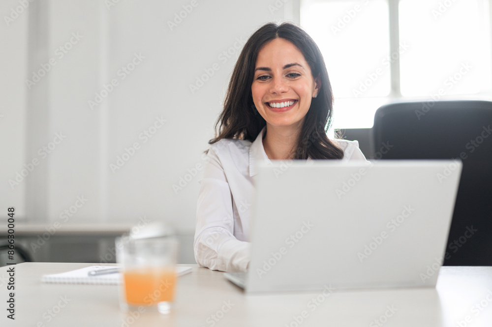 Young attractive brunette working on her lap top Young attractive brunette working on her lap top