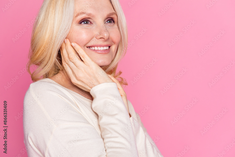 Photo of cheerful lovely pensioner woman wear trendy clothes look empty space isolated on pink color background Photo of cheerful lovely pensioner woman wear trendy clothes look empty space isolated on pink color background