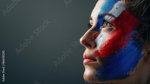 A woman's portrait with the French flag painted on her face. Football or soccer team supporter, sporting event, notion of patriotism and facial painting. studio image photo