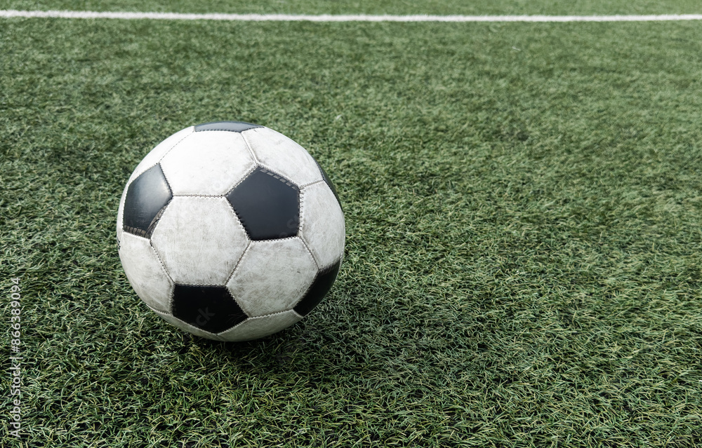 Black and white soccer and football ball in the field. Horizontal sport theme poster, greeting cards, headers, website and app Black and white soccer and football ball in the field. Horizontal sport theme poster, greeting cards, headers, website and app