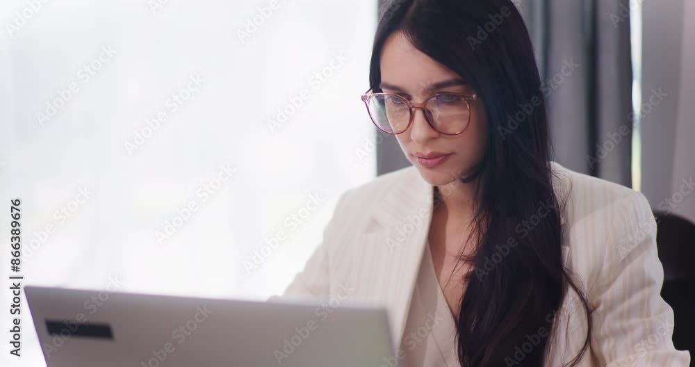 Confident Woman Works on Laptop and Responds to Emails Confident Woman Works on Laptop and Responds to Emails