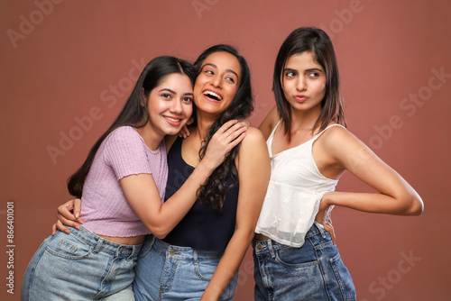 Three Prettiest Models Are Posing While Smiling And Hugging Each Other