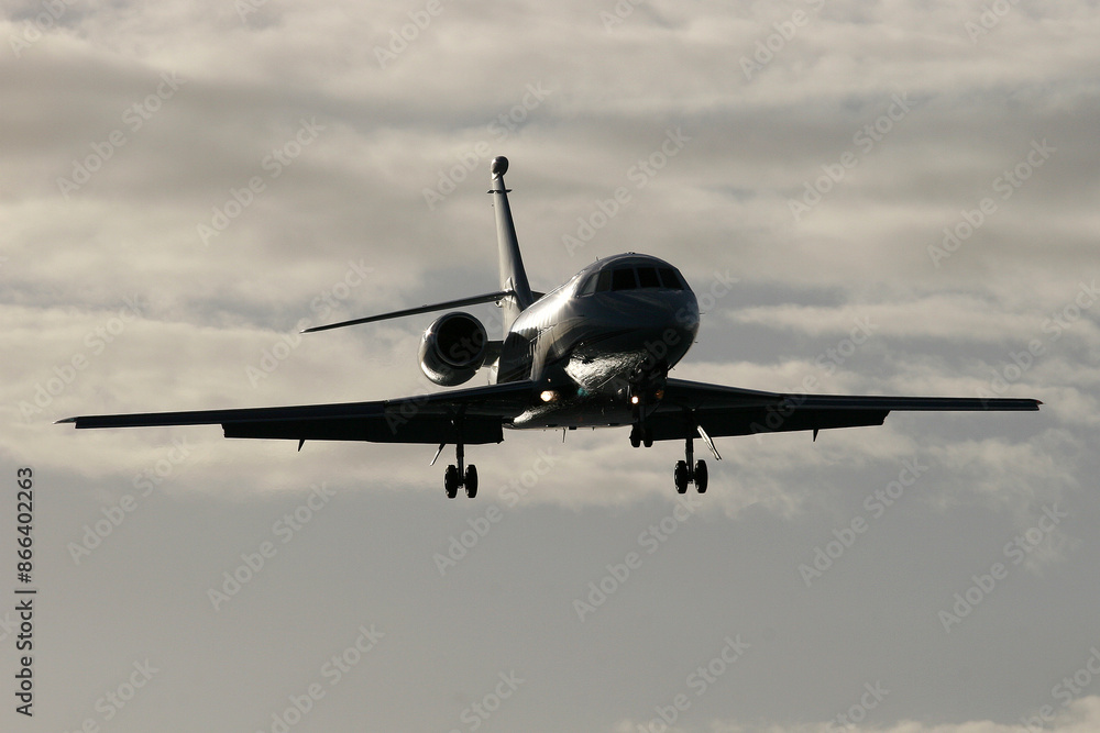 Dassault Falcon 2000 N88DD laning over Maho Beach Sint Maarten at dusk Dassault Falcon 2000 N88DD laning over Maho Beach Sint Maarten at dusk