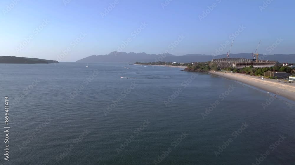 Langkawi coastline showing hotels and resorts on a tropical beach with tourists enjoying the clear blue water. Nice aerial view flight
fly reverse drone Langkawi coastline showing hotels and resorts on a tropical beach with tourists enjoying the clear blue water. Nice aerial view flight
fly reverse drone