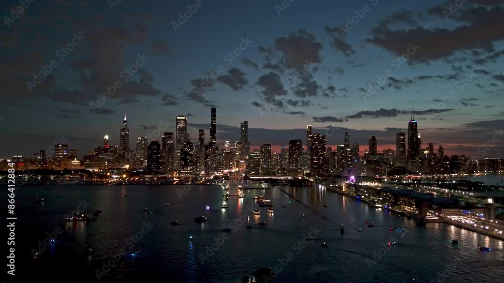 AERIAL: boat traffic on Lake Michigan with Chicago skyline background, moody dusk AERIAL: boat traffic on Lake Michigan with Chicago skyline background, moody dusk