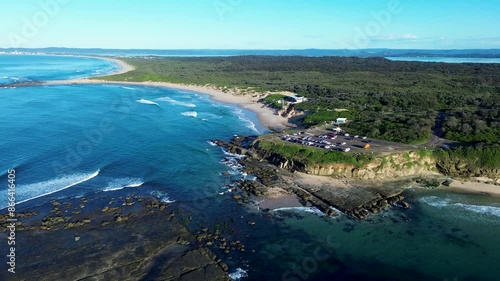 Landscape view of Soldiers beach carpark and surf clubhouse rocky headland cliff hill ocean waves coastal rural town suburbs of Central Coast Australia travel holidays photo