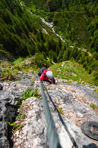 Top Down View on a Climber Climbing up a Natural Stone Cliff Wall in a Beautiful Black Forest Nature Having Great Experience
