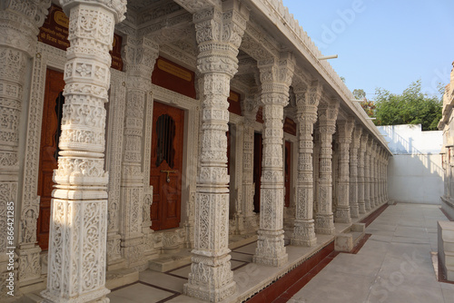  A Jain temple built in white marble with sculptures carved on the exteriors dedicated to Lord Mahavira  .at Udaipur in Rajasthan, India.. photo