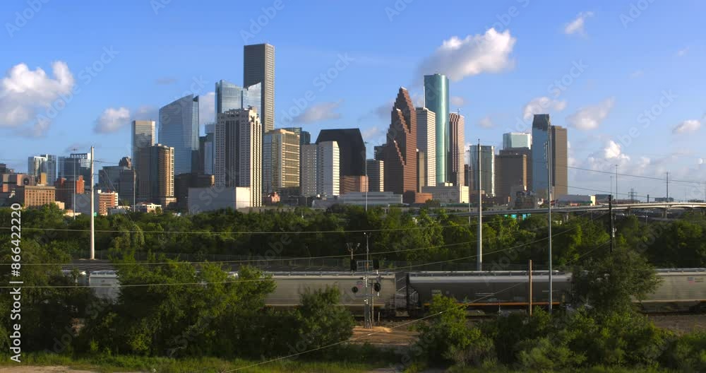 Establishing shot of downtown Houston, Texas on cloudy but sunny day as train passes by Establishing shot of downtown Houston, Texas on cloudy but sunny day as train passes by