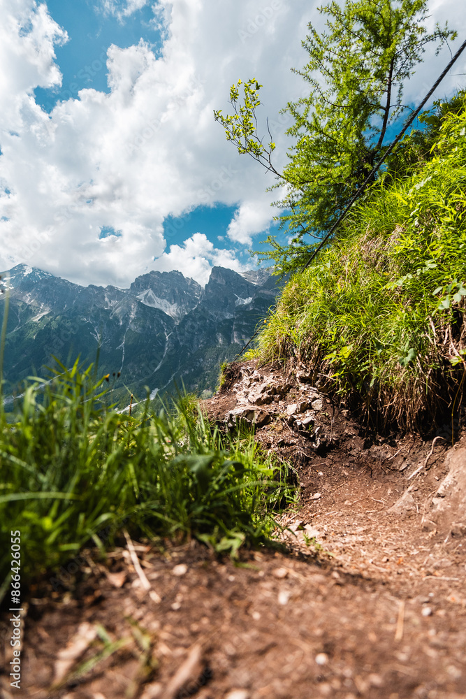 Fototapeta premium Small Hiking Path in Amazing Mountain Landscape Viewed from Ground Level
