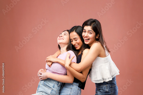 Group Of Three Friends Standing Together And Smiling At The Camera