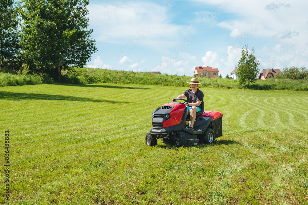 Man on lawn tractor mowing lawn on backyard. The red rider. The lawnmower tractor. High quality 4k footage Man on lawn tractor mowing lawn on backyard. The red rider. The lawnmower tractor. High quality 4k footage
