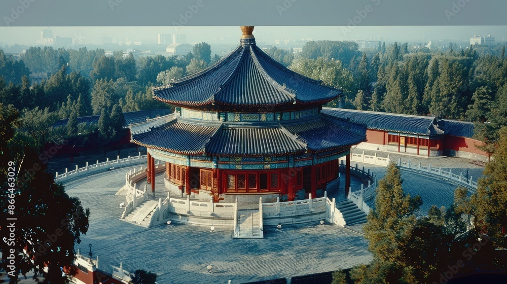 Obraz premium Aerial view of a historic Chinese temple with traditional architecture surrounded by lush greenery and trees under a clear blue sky.