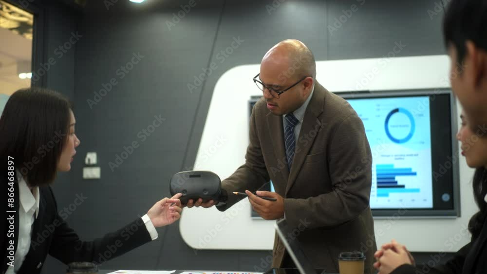 Motivated young business man lead meeting and present using virtual reality technology to diverse colleagues, leader man talking business project discussion with partnership to brainstorm at office.
Motivated young business man lead meeting and present using virtual reality technology to diverse colleagues, leader man talking business project discussion with partnership to brainstorm at office.