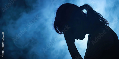 Domestic Violence: A silhouette of a person cowering in fear, symbolizing the impact of domestic violence photo