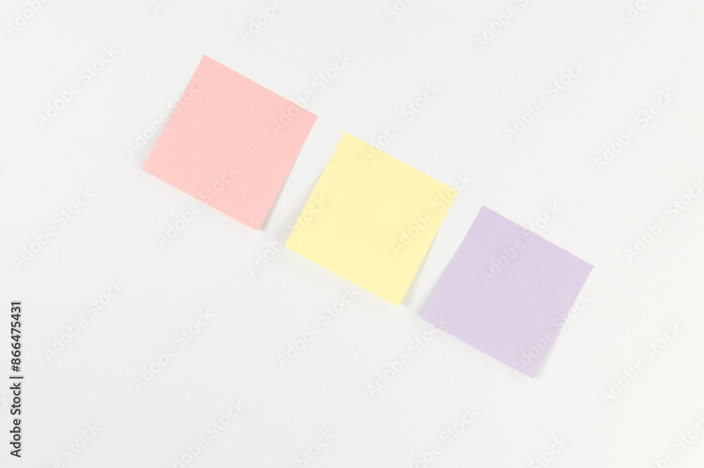 Top view of colorful sticky notes on white background. School, office wallpaper. Flat lay, copy space. Top view of colorful sticky notes on white background. School, office wallpaper. Flat lay, copy space.